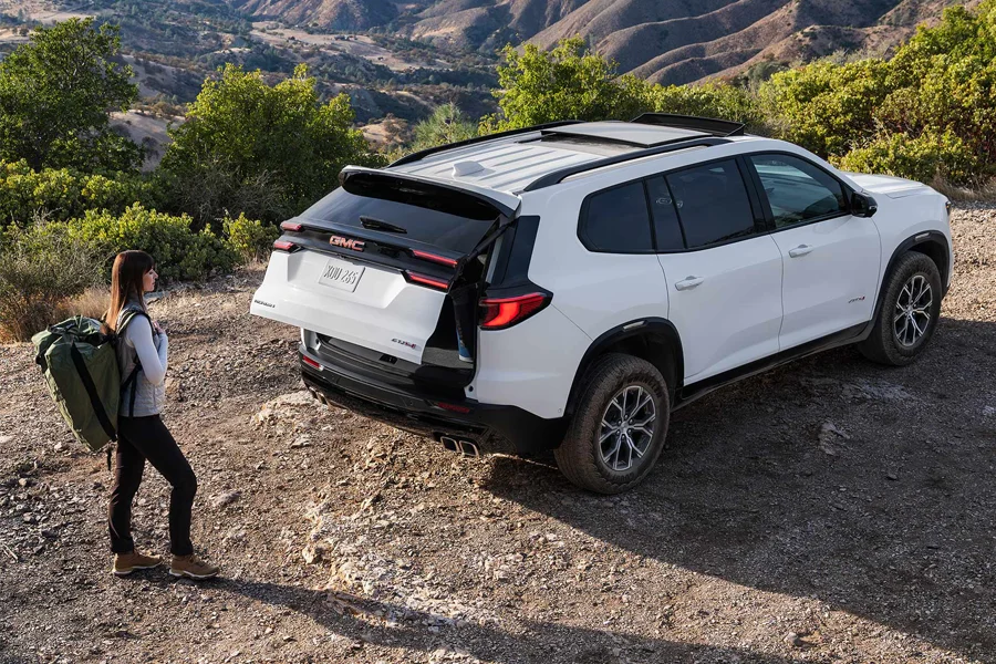 Buy Your 2026 GMC Acadia from Diamond Chevy GMC in Auburn, MA Woman Walking Up To 2026 GMC Acadia