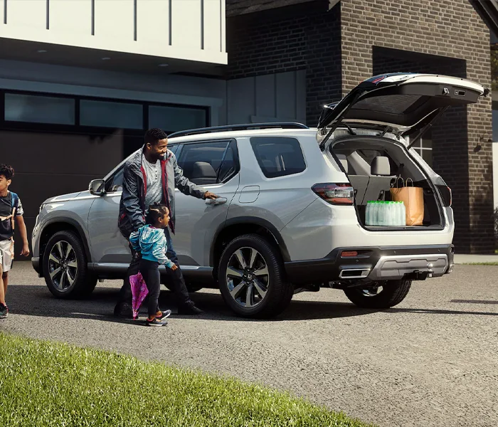 Family Walking To Honda Pilot