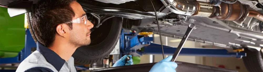 Honda Service Tech Looking Under Vehicle
