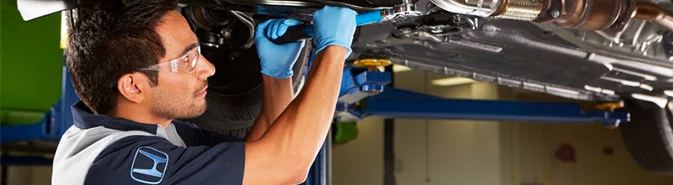 Honda Service Tech working on a car