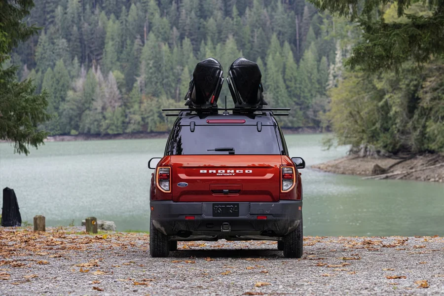 Why Buy At Mathieu Ford Ford Bronco Sport with a kayaks on top near a lake
