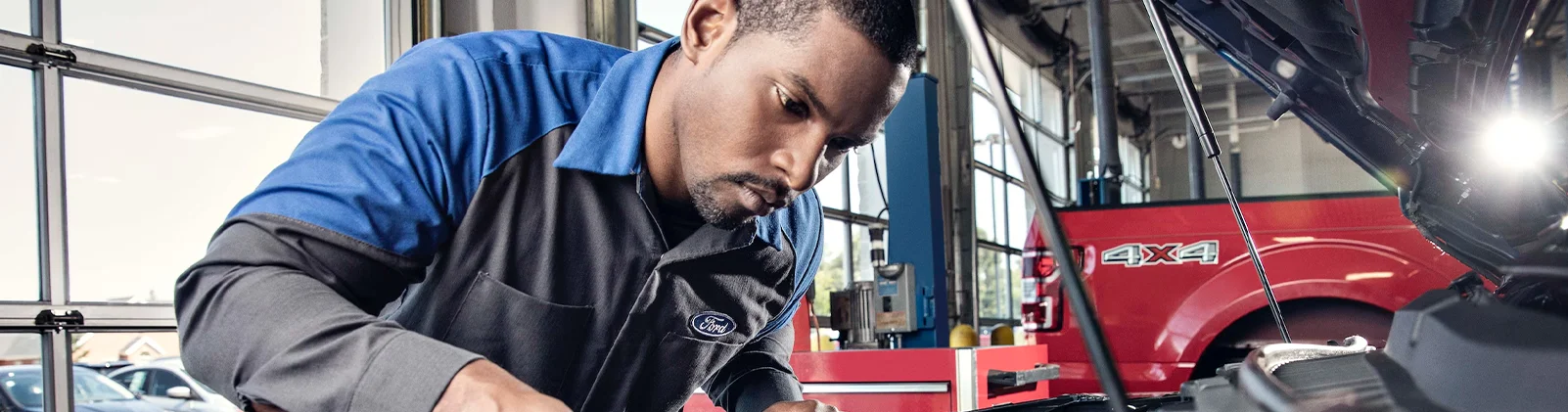 Service Tech Checking Oil Trusted Ford Service Near Fitchburg, MA