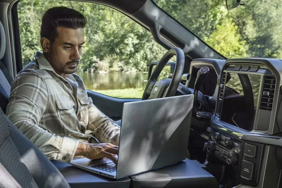 Man Using Laptop On Center Console of 2025 Ford F-150