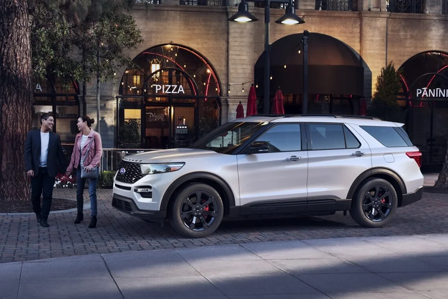 Couple In Front of Ford Explorer