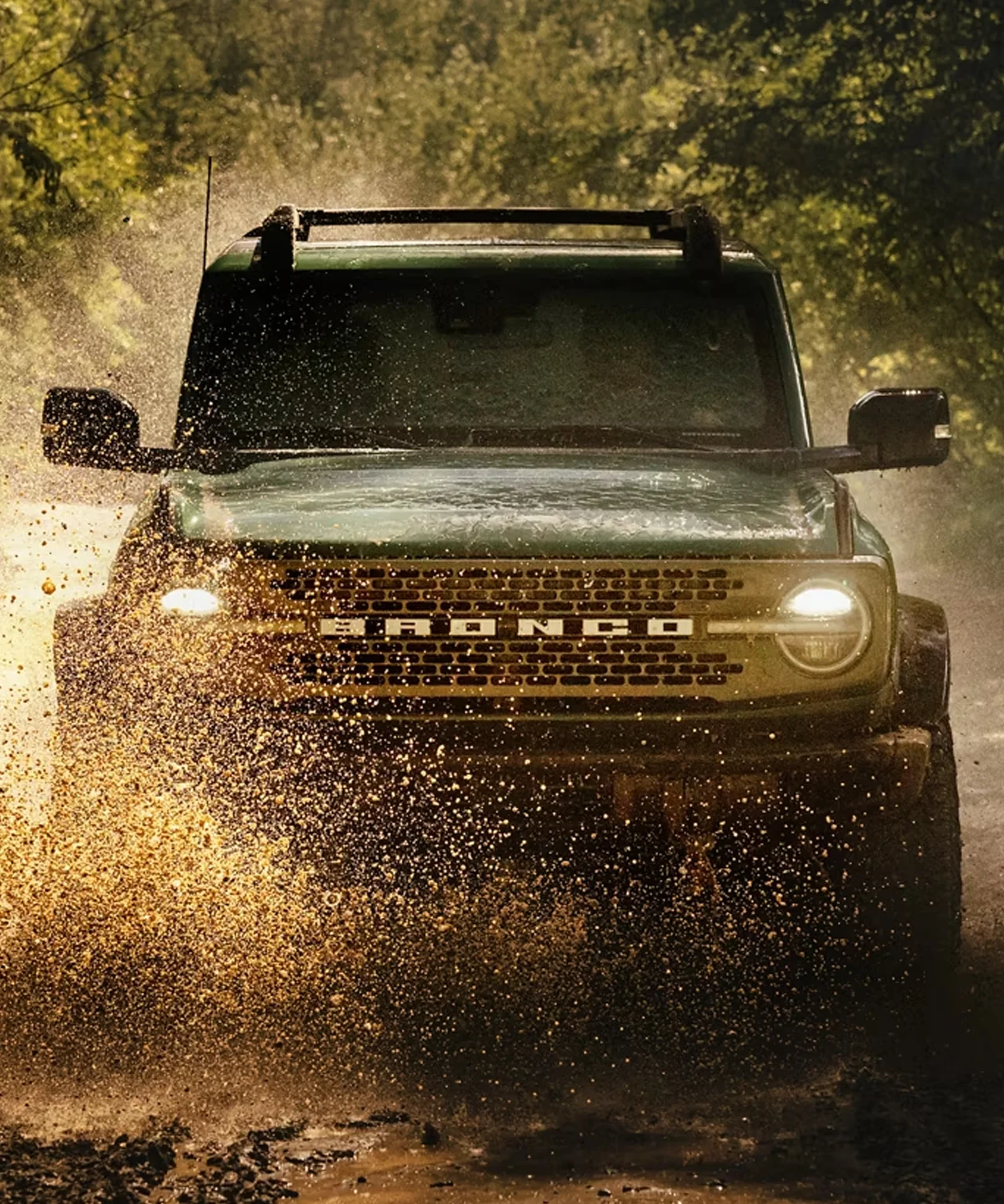 Ford Bronco driving through mud