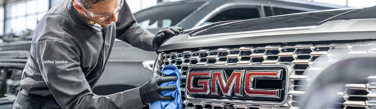 GMC Service tech working on vehicle